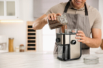 Мелница за кафе 150W 200g 8 Man,Using,Electric,Coffee,Grinder,In,Kitchen,,Closeup